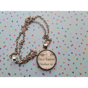 I'm a Taurus pendant necklace made from The Kiss Curse book pages